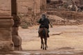 Bedouin riding a Camel in Petra, Jordan Royalty Free Stock Photo