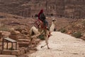 Bedouin riding a Camel in Petra, Jordan Royalty Free Stock Photo