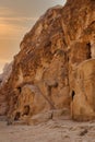 Bedouin sitting on carpet near a stairs carved on rocks