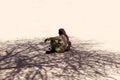 Bedouin is sitting on the sand in the shade of a tree in the desert in Egypt Dahab South Sinai