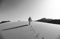 Bedouin Walking on the Sand Dunes in Wadi Rum Desert, Jordan in Black and White Royalty Free Stock Photo