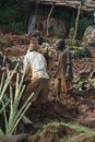 Mudbrick former standing barefoot in clay in Uganda