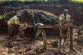 Mudbrick former standing barefoot in clay in Uganda