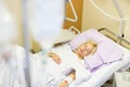 Bedridden female patient recovering after surgery in hospital care.