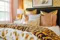 Bedroom accessories with animal print. Bed with animal patterned cushions. Generative AI