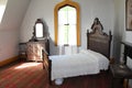 An old-fashioned late 19th century bedroom in a manor home in Sherbrooke village Nova Scotia Royalty Free Stock Photo