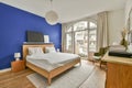 a bedroom with a bed and a blue accent wall Royalty Free Stock Photo