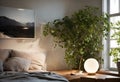 A bedroom with a bed, a lamp, a plant, a painting, and a window Royalty Free Stock Photo