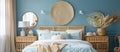 Bedroom with bed, nightstands, mirrors, and blue walls in wood building Royalty Free Stock Photo