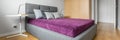 Bedroom with big grey bed, panorama Royalty Free Stock Photo