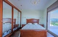 Bedroom in classic style. Luxury mahogany furniture. Wardrobe w