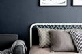 Bedroom corner setting with comfortable graphic pillows in neutral color with navy blue painted wall/ comfortable interior / inter Royalty Free Stock Photo