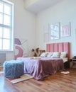 Bedroom decor in loft style. The interior colors are pink and beige. Royalty Free Stock Photo