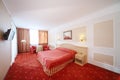 Bedroom with double bed with red linen, red armchairs Royalty Free Stock Photo