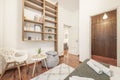 bedroom with double bed with white folded towels, wardrobe