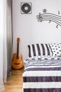 Bedroom with a guitar next to the bed
