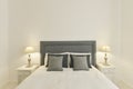 Bedroom headboard upholstered in gray fabric with matching