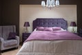 Bedroom interior. The bedroom is decorated in purple shades. Fashionable color 2022 very peri