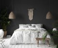 Bedroom interior with black wall,boho style decor and white bed