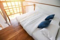 Bedroom interior design white and wooden floor - morning bedroom with sunlight and nature view on window Royalty Free Stock Photo