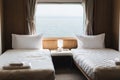 Bedroom with interior of double passenger cabin ferry ship with ocean view. Royalty Free Stock Photo