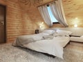 Bedroom interior in a log on the attic floor with a roof window. Royalty Free Stock Photo