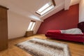 Bedroom interior in luxury red loft, attic, apartment with roof