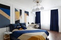 Bedroom interior in modern style with a large bed and paintings Royalty Free Stock Photo