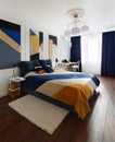 Bedroom interior in modern style with a large bed and paintings Royalty Free Stock Photo