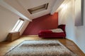 Bedroom interior in luxury red loft, attic, apartment with roof Royalty Free Stock Photo