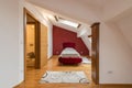 Bedroom interior in luxury red loft, attic, apartment with roof