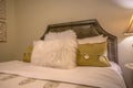 Bedroom interior with pillows against upholstered belgrave headboard of a bed