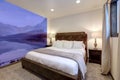 Bedroom interior with purple mountains on the walls and brown sude bed