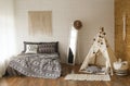 Bedroom interior style boho bed wigwam childrens room Royalty Free Stock Photo