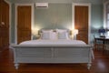 Bedroom with a king-size bed and white sheets inside a building in New Orleans Royalty Free Stock Photo