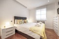 Bedroom with a king size bed with a yellow bedspread, matching