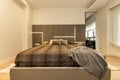 Bedroom with large designer double bed in brown upholstered leather Royalty Free Stock Photo