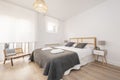 Bedroom with a large double bed with a wooden headboard,