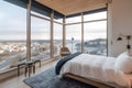 A bedroom with a large window overlooking a city Royalty Free Stock Photo