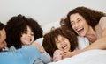 Bedroom, laughing and face of parents, children or happy family relax, bond and enjoy funny morning together. Bed