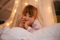 Bedroom, lights and portrait of child at night for resting, relaxing and dreaming in home. Happy, smile and face of Royalty Free Stock Photo