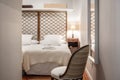 Bedroom with metallic gold headboard, upholstered armchair and wooden