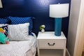 Bedroom with Nightstand, Lamp & Blue Accent Wall Royalty Free Stock Photo