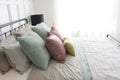 Bedroom with pastel pink and green accents pillows. Royalty Free Stock Photo