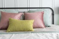 Bedroom with pastel pink and green accents pillows. Royalty Free Stock Photo