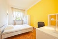 Bedroom for rent in renovated apartment with yellow wall and white desk