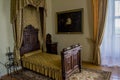 Bedroom room interior with bed, picture, curtains in the ancient old castle Royalty Free Stock Photo