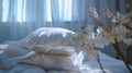 A bedroom setting with a plush white comforter and a stack of luxurious silk pillowcases on the bed creating a serene Royalty Free Stock Photo
