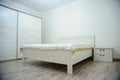 soft light colors. big comfortable double bed in elegant classic bedroom Royalty Free Stock Photo