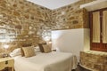 Bedroom with stone walls. Comfortable modern hotel room. Interior Royalty Free Stock Photo